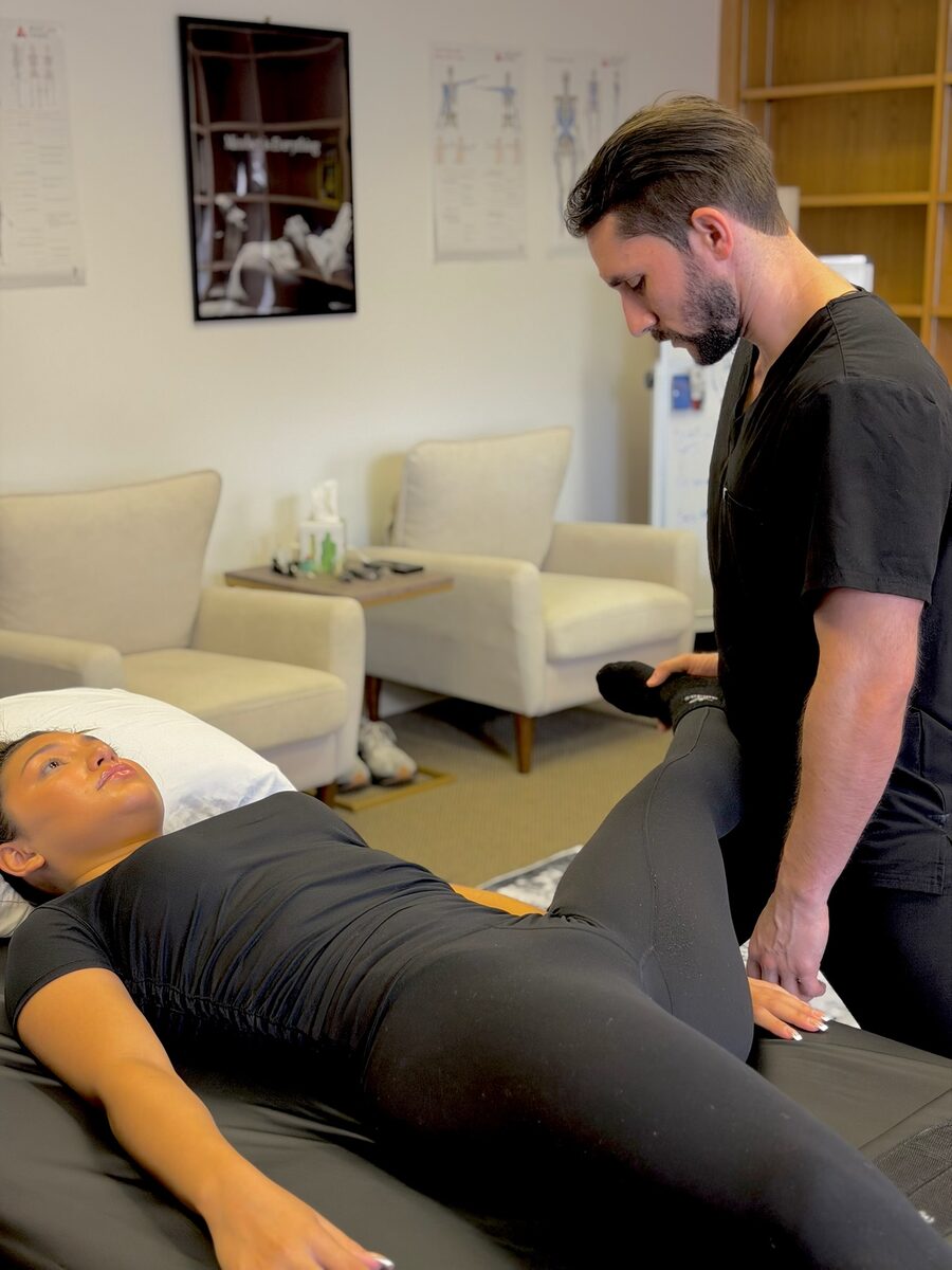 Joan working with a client on the table at Stretch Therapy HTX