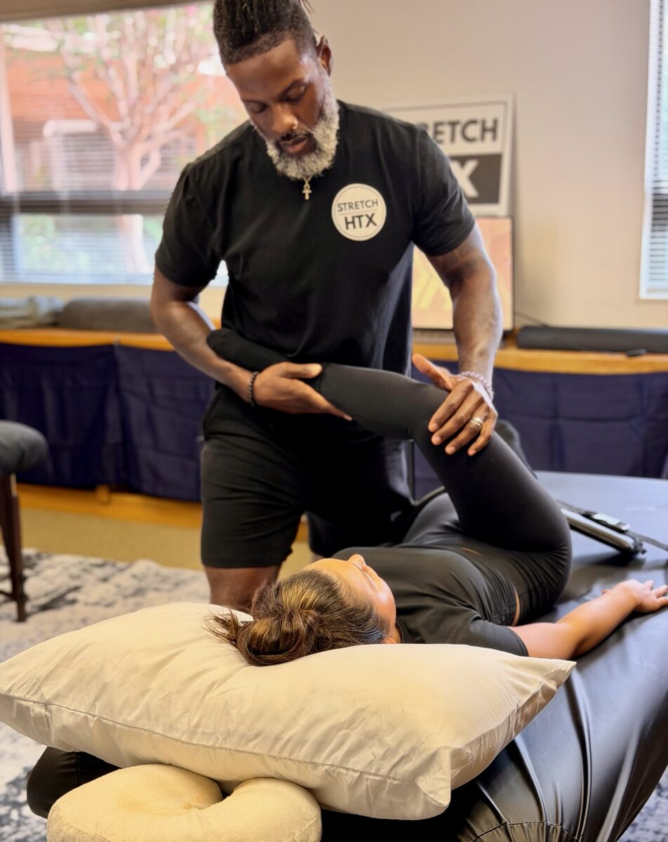 Aaron performing an assisted hamstring stretch at Stretch Therapy HTX