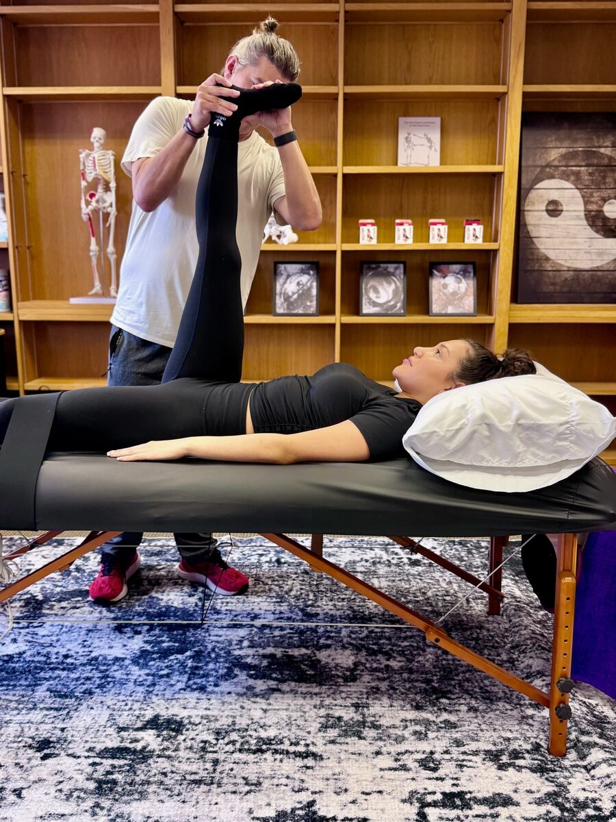 Assisted hamstring stretch with stabilization strap